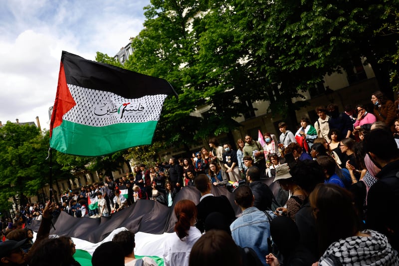 Demonstrators wave a large Palestinian flag outside the Sorbonne. EPA
