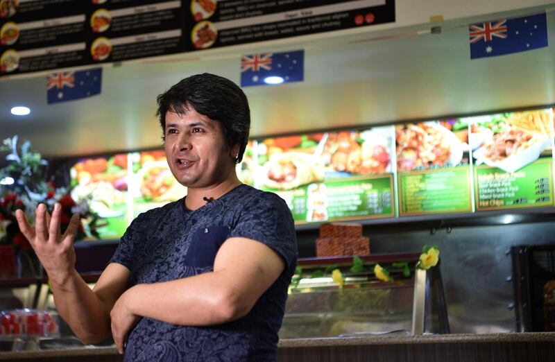 This photo taken on September 28, 2018 shows Hazara refugee Ali speaking to AFP in his "Afghan Friendship Restaurant" in Griffith, a tribute to the warm welcome he says he received after moving to the town five years ago.  The 44-year-old father of three is among a growing number of refugees and migrants to Australia who have opted to live in the bush rather than among the bright lights, hustle-bustle and astronomical prices of Sydney or Melbourne. - To go with Australia-immigration-refugee-rural-lifestyle-Afghanistan, FEATURE by Glenda KWEK
 / AFP / PETER PARKS / To go with Australia-immigration-refugee-rural-lifestyle-Afghanistan, FEATURE by Glenda KWEK
