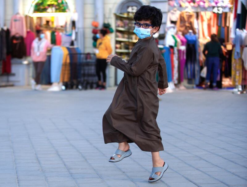 Abu Dhabi, United Arab Emirates, January 10, 2021.  A boy hops to the Emirati music at the Sheikh Zayed Festival.
Victor Besa/The National
Section:  NA
Reporter:  Saeed Saeed