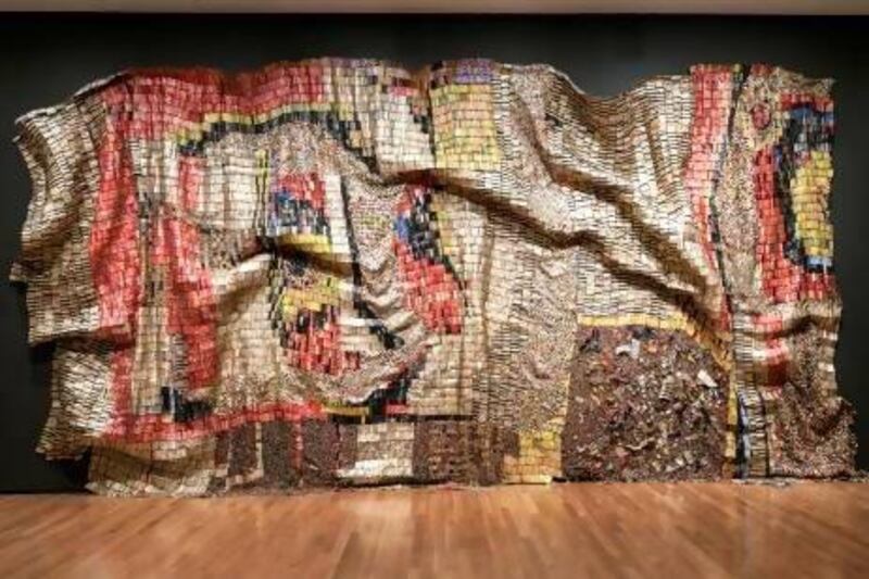 The artist El Anatsui worked with a team of assistants to link crushed aluminum with copper wire to create Earth's Skin. Courtesy Akron Art Museum