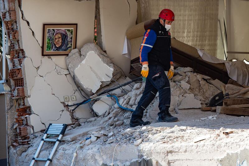 A rescue worker walks in a room of a partially collapsed building in Izmir. AFP