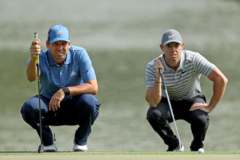 DUBAI, UNITED ARAB EMIRATES - JANUARY 25:  Rory McIlroy of Northern Ireland and Sergio Garcia of Spain line up their putts on the par 4, ninth hole during the first round of the Omega Dubai Desert Classic on the Majlis Course at Emirates Golf Club on January 25, 2018 in Dubai, United Arab Emirates.  (Photo by David Cannon/Getty Images)