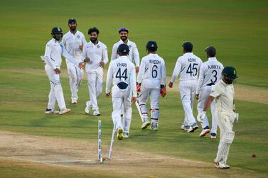 India celebrate the wicket of South Africa's Dane Piedt, right, during the second day of the first Test in Visakhapatnam. AFP