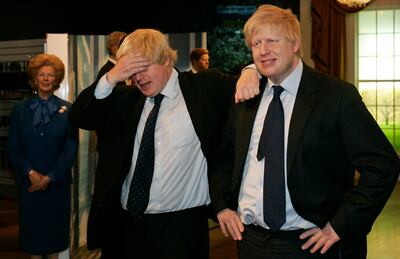 Then mayor of London Boris Johnson poses with a wax figure of himself at Madame Tussauds wax museum in London in 2009. AP Photo