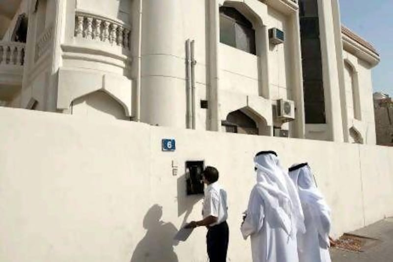 DEWA officials check the meter of a villa that will have its' power cut in Jafliya, Dubai.