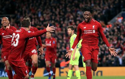 Liverpool's Divock Origi, right, celebrates scoring his side's fourth goal of the game during the Champions League Semi Final, second leg soccer match between Liverpool and Barcelona at Anfield, Liverpool, England, Tuesday, May 7, 2019. (Peter Byrne/PA via AP)