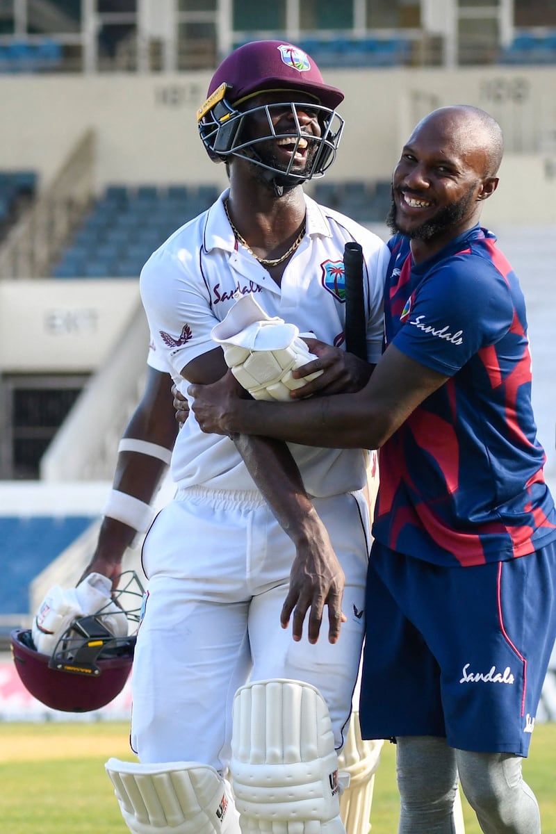 Kemar Roach, left, and Jermaine Blackwood celebrate West Indies' one-wicket win against Pakistan in the first Test at Sabina Park, Kingston.