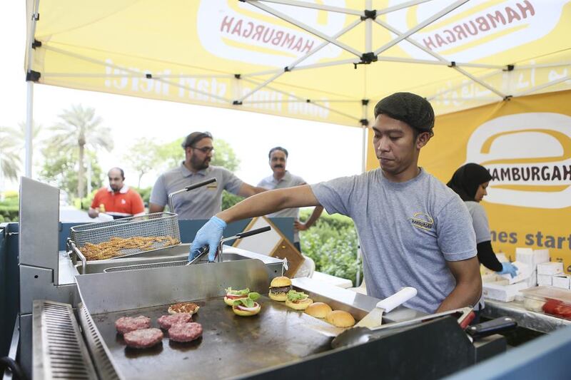 A worker prepares mini burgers at the Hamburgah stand. Sarah Dea / The National