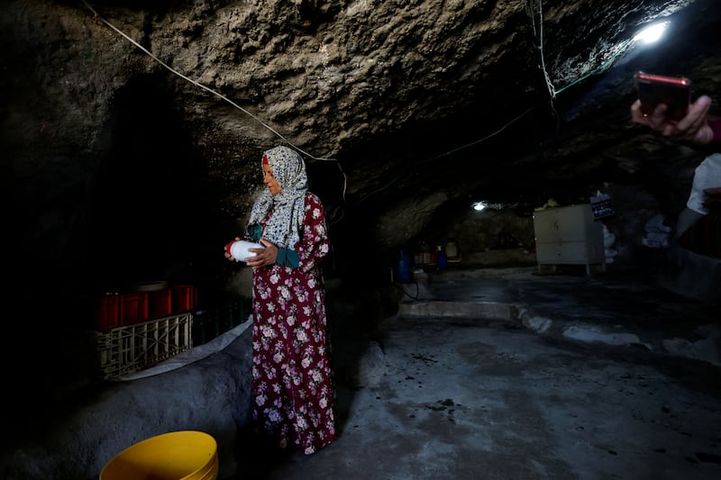 A woman arranges her belongings in the cave where she lives but she faces eviction, as do more than 1,000 Palestinians in  Masafer Yatta. 