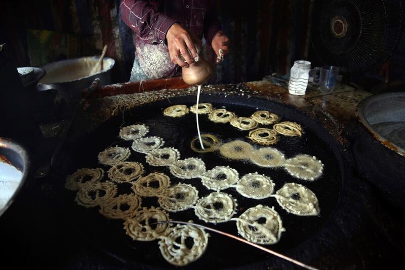 Afghan men prepare sweets at a traditional bakery for Eid Al Fitr holiday to mark the end of Ramadan. AP