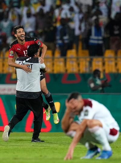 Egypt's Ahmed Fatouh, top, is carried by a team staff member as they celebrate at the end of the African Cup of Nations 2022 quarter-final soccer match between Egypt and Morocco in Yaounde, Cameroon. AP.