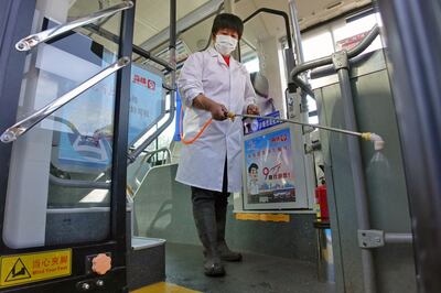 Disinfectant is sprayed on a bus in Yantai to prevent Covid-19.  AFP
