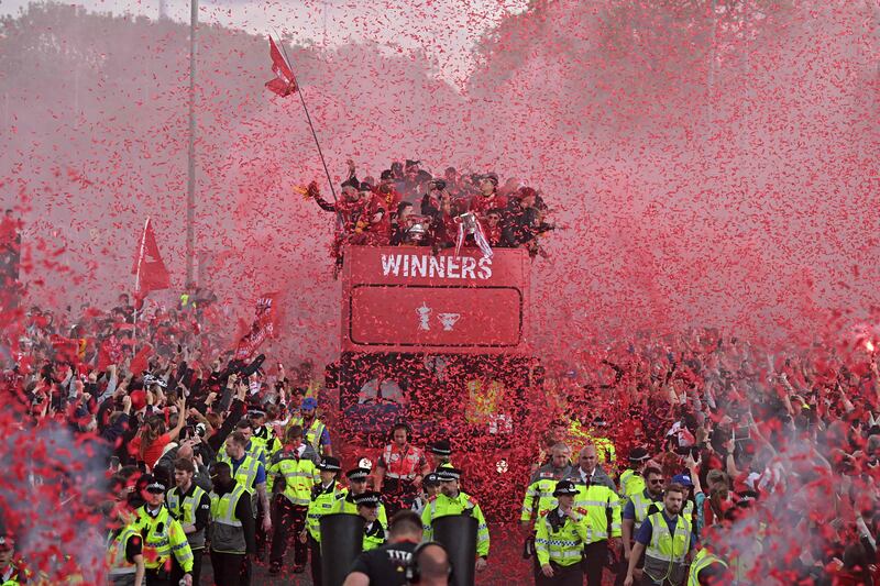 Liverpool footballers on an open-top bus parade through the city in north-west England to celebrate winning the League Cup and FA Cup. AFP