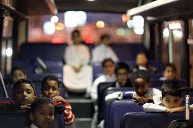 January 11, 2011 / Abu Dhabi / Children use the school bus to get to school at 6:30am. Emirates Transport runs school buses to take children to school every morning in Abu Dhabi January 11, 2011 . (Sammy Dallal / The National)