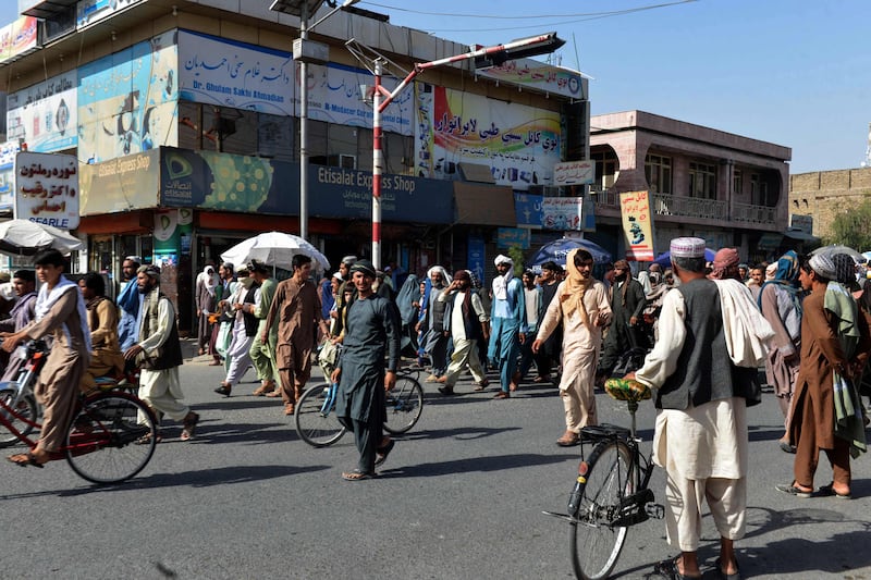 Local residents take part in a protest march against a reported announcement by the Taliban, asking them to evict their homes built on state-owned land in Kandahar.  AFP