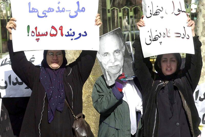 Ms Mohammadi is the wife of dissident Taqi Rahmani, right, pictured protesting in Tehran in 2002. AP Photo