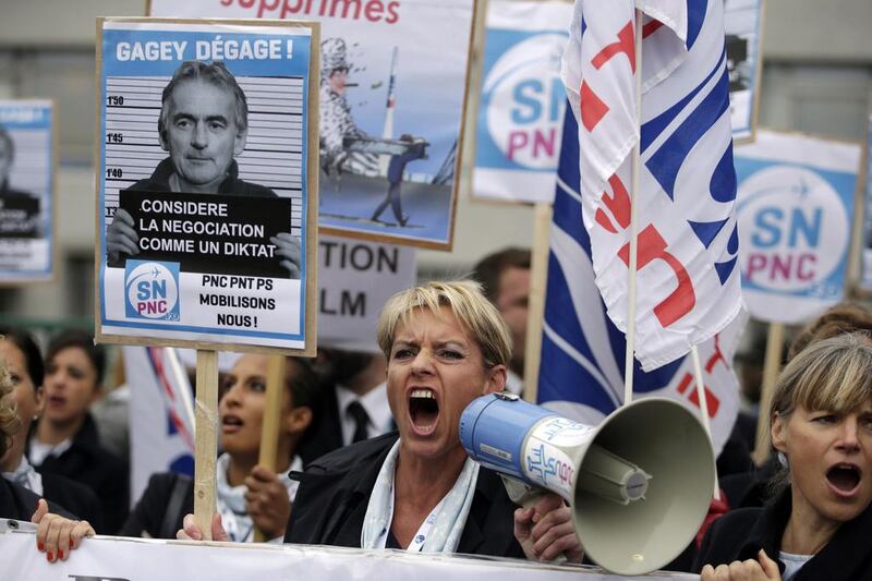 Employees of Air France shout slogans during  a demonstration in front of the company headquarters. Kenzo Tribouillard / AFP