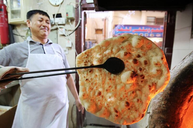 A baker makes Iranian bread - known as taftoon - at a bakery in Kuwait City. AFP