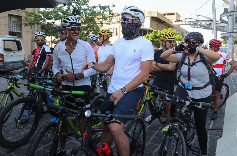 US former professional cyclist Lance Armstrong along with Lebanese sportsman Maxime Chaya prepare to lead "Bike for Beirut" charity tour at the site of the August 4 port explosion.  AFP