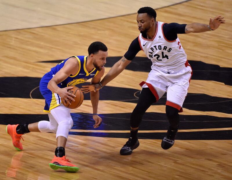 Golden State Warriors guard Stephen Curry drives by Toronto Raptors forward Norman Powell. EPA