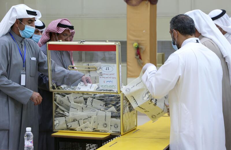 A Kuwaiti judge and his aides count the ballots at a polling station at the end of the parliamentary elections vote, in the Abdullah al-Salem district of Kuwait city. AFP