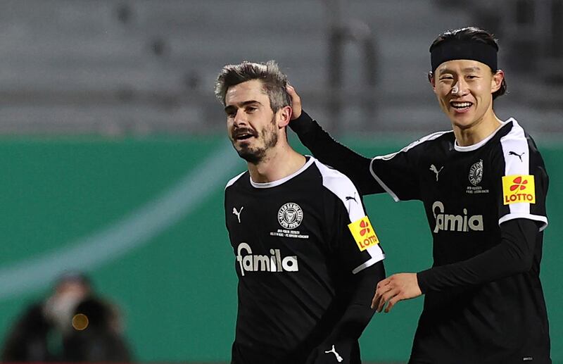Kiel's Fin Bartels celebrates with Jae-sung Lee after scoring their first goal. AP