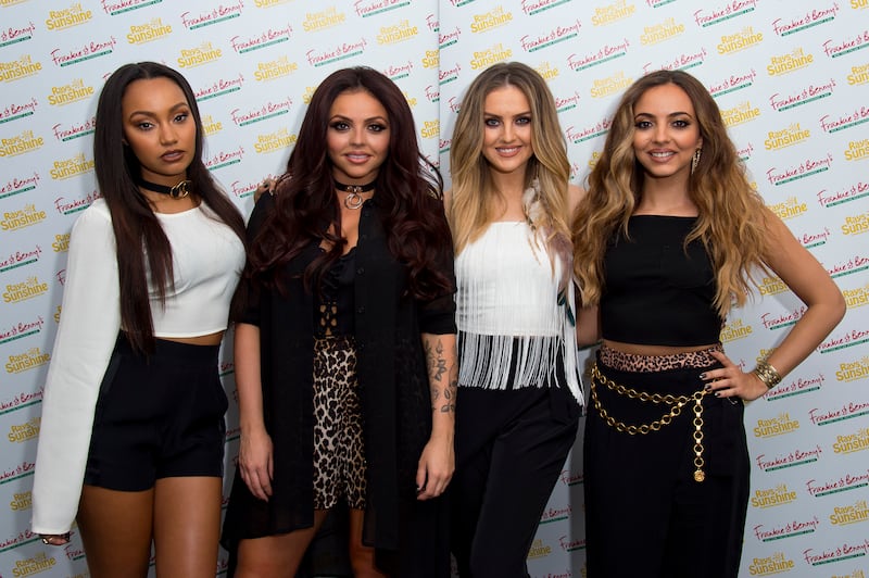 Jesy Nelson, in a leopard print skirt and black sheer blouse, with her Little Mix bandmates at Frankie and Benny's Rays of Sunshine Concert on June 7, 2015 in London