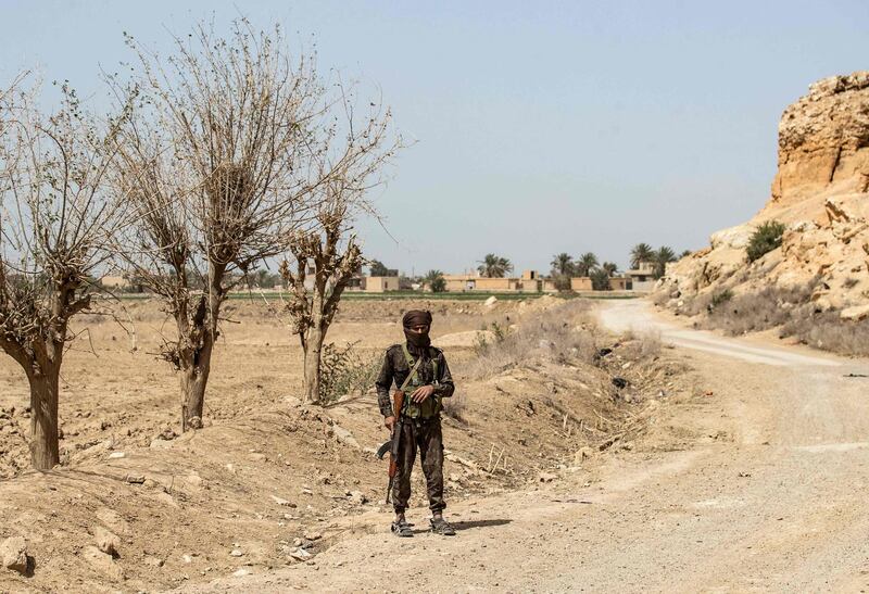 A fighter with the Kurdish-led Syrian Democratic Forces stands guard on a road on the outskirts of Baghouz village in Deir Ezzor province, northern Syria. Two years ago, ISIS made its last stand in Baghouz and was defeated. AFP