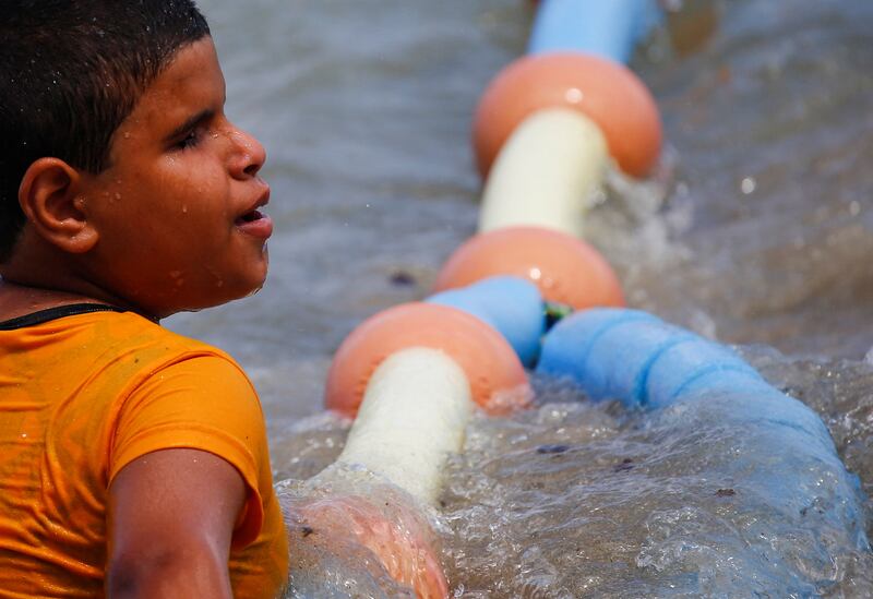 Ghamies Abdelrahman, 13, a visually impaired child, enjoys the water at Al Mandara beach. Reuters