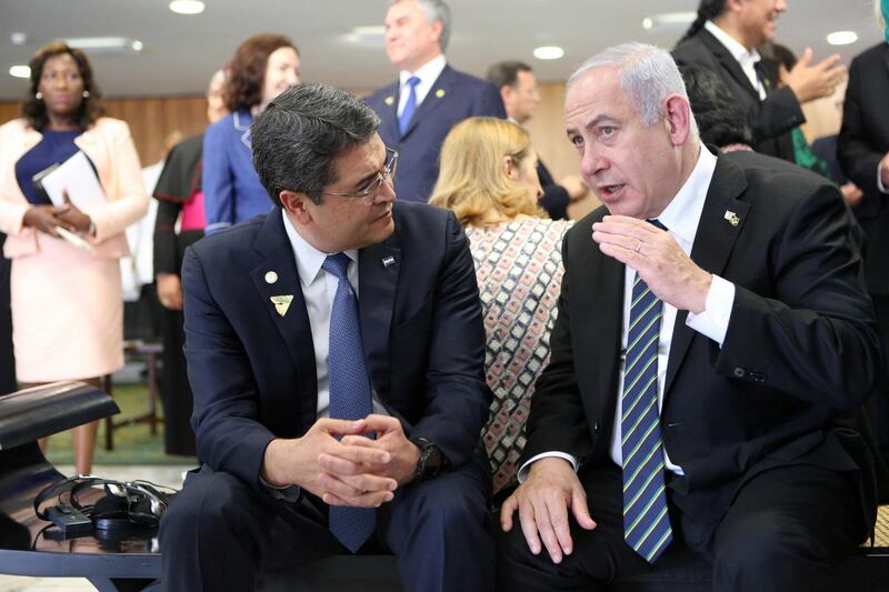 Israeli Prime Minister Benjamin Netanyahu speaks with Honduras' President Juan Orlando Hernandez during a meeting in Brasilia, Brazil January 1, 2019. Presidency Honduras/Handout via REUTERS ATTENTION EDITORS - THIS PICTURE WAS PROVIDED BY A THIRD PARTY.