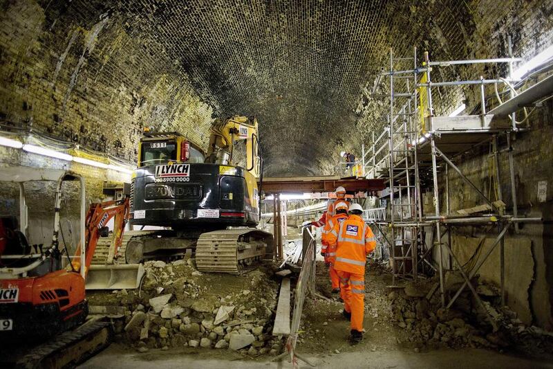 Visitors walk past excavating machinery inside the Connaught Tunnel, which is being brought back into use for the Crossrail project. Adrian Dennis / AFP