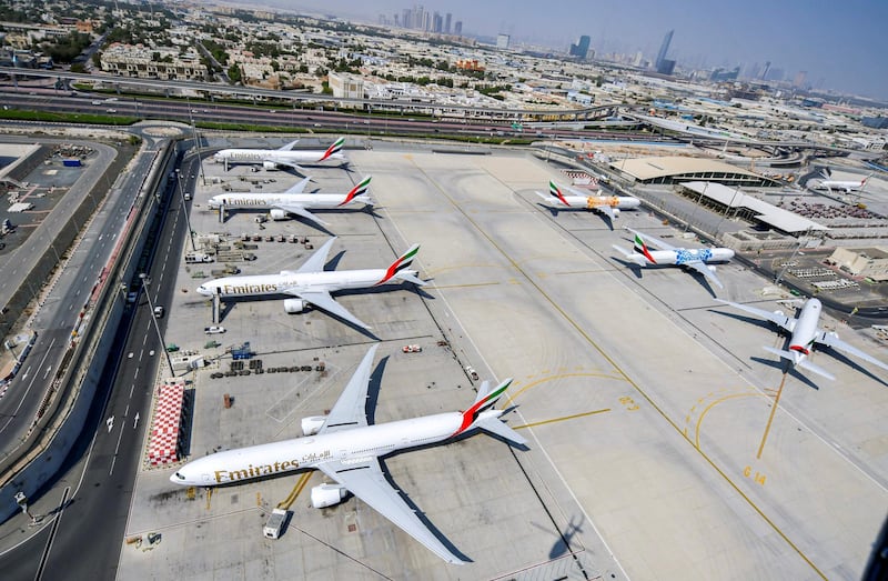 This picture taken on July 8, 2020 shows an aerial view of Emirates aircraft parked on the tarmac at Dubai International Airport (DXB), serving the Gulf emirate of Dubai, during a government-organised helicopter tour. (Photo by KARIM SAHIB / AFP)
