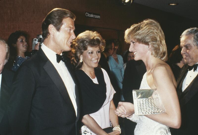 Roger Moore and his wife Luisa meet Diana, Princess of Wales, wearing Hachi, at a premiere at the Odeon Leicester Square in London, England, on June 6, 1983. Getty Images
