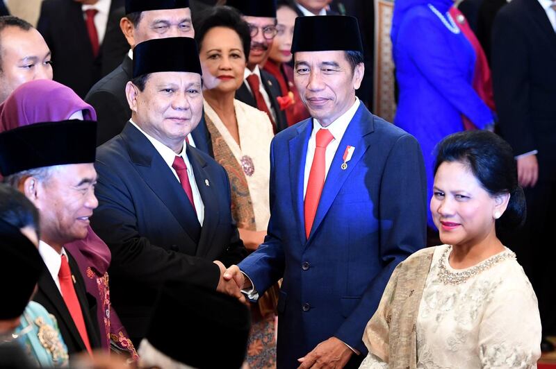 Indonesian Defense Minister Prabowo Subianto is congratulated by Indonesian President Joko Widodo, as First Lady Iriana Widodo stands next to them, after the swearing-in ceremony during the inauguration at the Presidential Palace in Jakarta, Indonesia, October 23, 2019 in this photo taken by Antara Foto.  Antara Foto/Wahyu Putro A/ via REUTERS  ATTENTION EDITORS - THIS IMAGE WAS PROVIDED BY A THIRD PARTY. MANDATORY CREDIT. INDONESIA OUT.