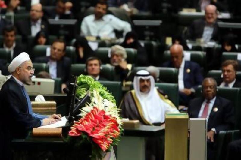 Iranian President Hassan Rouhani (left) speaks after being sworn in for a four-year presidential term at the parliament in Tehran.