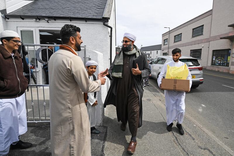 Aihtsham Rashid greets Iman Mufti Abdur Rahman Mangera at the opening of the first mosque built on the Western Isles, Stornoway, Scotland, on May 11, 2018. The former derelict building has been converted into the UK's most northern mosque, following a fundraising campaign which raised more the fifty nine thousand pounds towards construction costs. Jeff J Mitchell / Getty Images