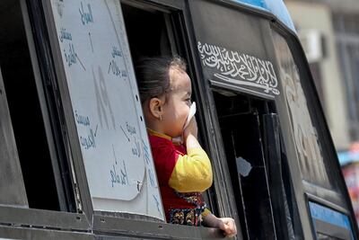 A girl protects her mouth with tissue, amid concerns over the coronavirus disease (COVID-19) looks throw window of bus in Cairo, Egypt, April 12, 2020. REUTERS/Mohamed Abd El Ghany
