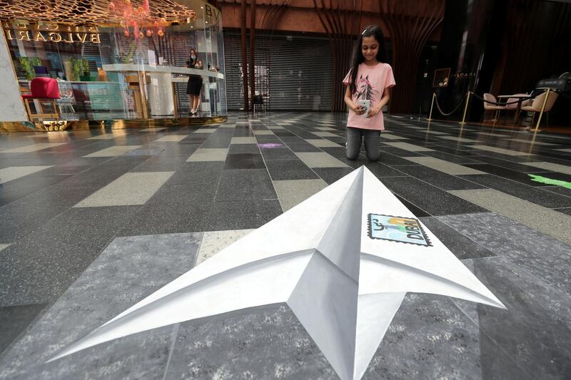 Dubai, United Arab Emirates - Reporter: N/A. Art. Mehr aged 8 takes a pic of the floor painting by Mahra Al Falahi at City Walk. Saturday, August 1st, 2020. Dubai. Chris Whiteoak / The National