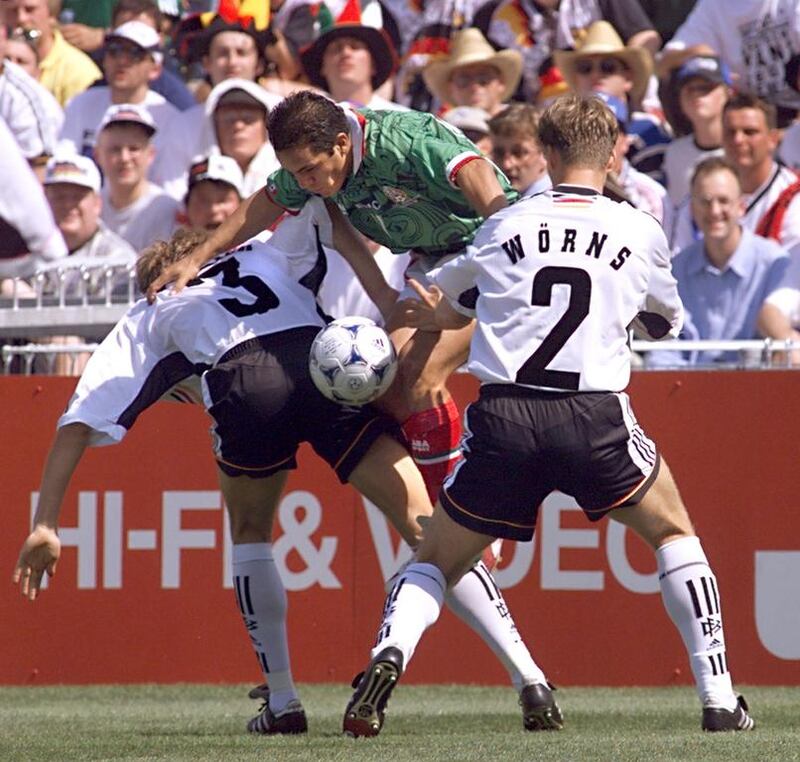 Mexican forward Cuauhtemoc Blanco (C) jumps between German Jorg Heinrich (L) and Christian Woerns 29 June at the Stade de la Mosson in Montpellier, south of France, during the 1998 World Cup s match between Germany and Mexico. AFP / PATRICK HERTZOG