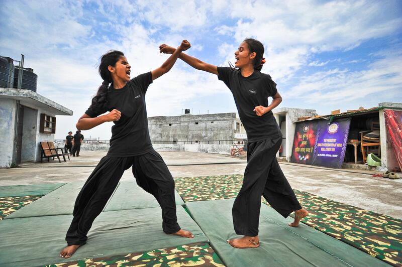 Young women from the Red Brigade take part in a martial arts training session on the roof of a building in the city of Lucknow. The Red Brigade was formed in November 2010 to fight back against a growing number of sexual attacks on women in the Madiyav area of the city of Lucknow, in Uttar Pradesh state, India.
The group of young women wear distinctive red and black salwar kameez. Most have been victims of sexual assault and have resolved that they will take no more. They take direct action against their tormentors and now when a local man steps out of line, he can expect a visit from the Red Brigade and a thrashing.