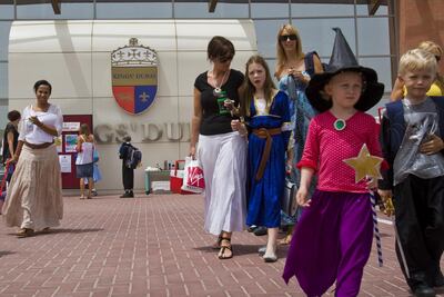 Children dressed-up in costumes, prepare to leave school, during the last day of class before Easter vacations, at Kings' Dubai school, in Dubai, UAE, on April 2, 2009.