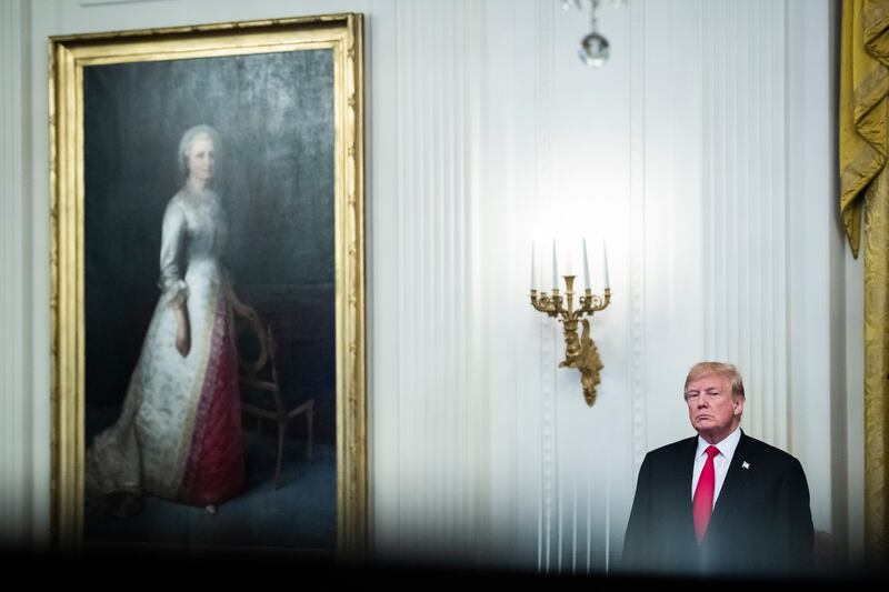 President Donald J Trump listens as first lady Melania Trump speaks on a year of historic progress and action combating the opioid crisis in the East Room of the White House on October 24, 2018, in Washington. Getty Images