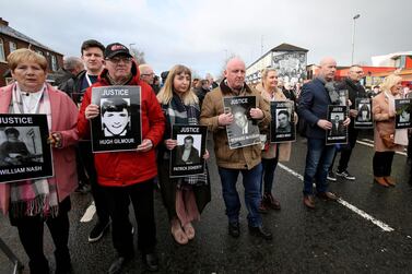 Relatives and supporters of the victims of the 1972 Bloody Sunday killings hold images of those who died as they march from the Bogside area of Derry, Northern Ireland. AFP
