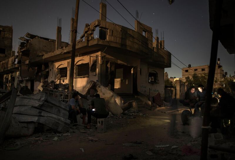 Palestinians spend the night next to their destroyed homes that bore the brunt of Israeli air strikes in the town of Beit Hanoun, northern Gaza Strip. AP Photo