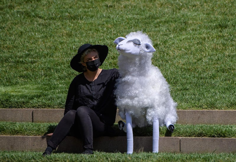 A Basil Twist puppeteer with a sheep puppet before a New York Philharmonic performance at Hearst Plaza as part of Lincoln Centre's Restart Stages in New York City. The musicians performed for an audience of 150 healthcare workers on World Health Day, after being shut down since last March because of the pandemic. AFP