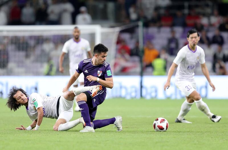 Al Ain, United Arab Emirates - December 18, 2018: River Plate's Gonzalo Martinez and Al Ain's Mohamed Abdulrahman battle during the game between River Plate and Al Ain in the Fifa Club World Cup. Tuesday the 18th of December 2018 at the Hazza Bin Zayed Stadium, Al Ain. Chris Whiteoak / The National