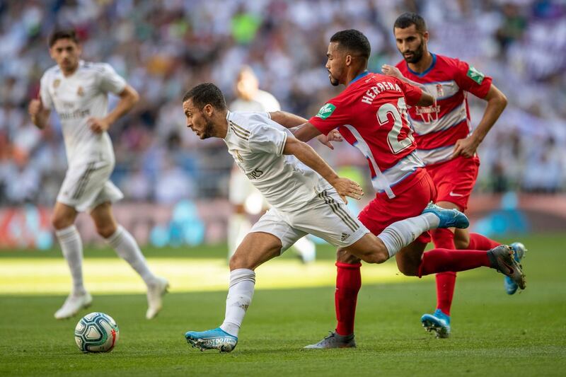 Real Madrid's Eden Hazard, left, runs with the ball against Granada. AP