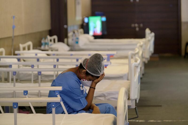 A nurse rests in a ward at an emergency Covid-19 centre set up in New Delhi, India. Bloomberg