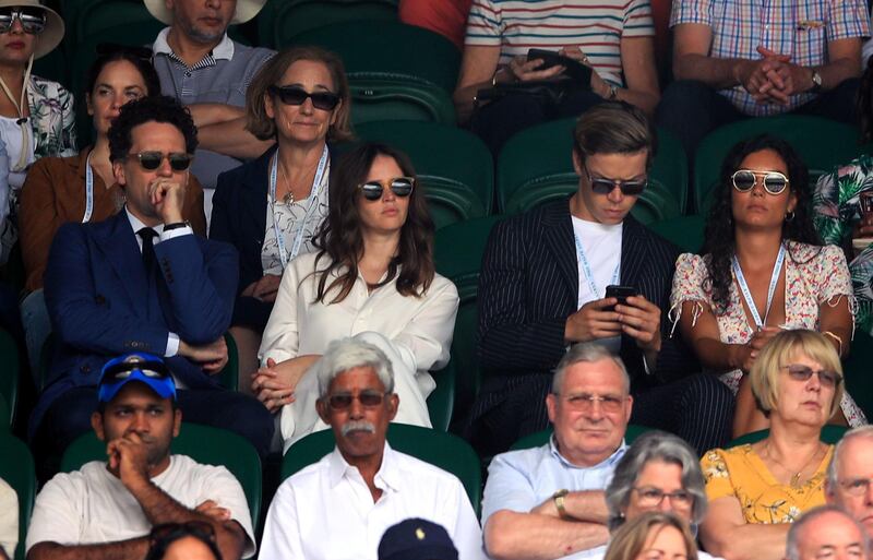 Charles Guard, Felicity Jones, in Ralph Lauren, and Will Poulter (centre left to right) on day seven of the Wimbledon Championships at the All England Lawn Tennis and Croquet Club. PA