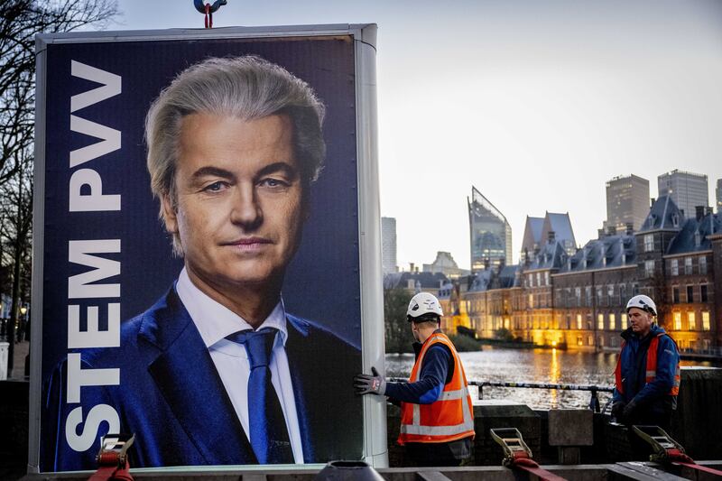 An election poster for Geert Wilders, leader of the Freedom party (PVV) is removed near the Dutch parliament buildings in The Hague, a day after the general elections. EPA